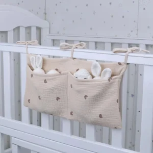 Crib Organizer Caddy hanging on baby crib storing diapers wipes and nursery essentials